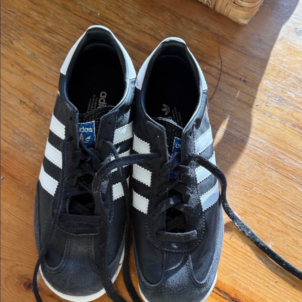 Adidas Kid’s Black and White Samba Sneakers, with cool textured tongue feature.